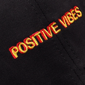 Black cotton twill baseball cap with yellow and red POSITIVE VIBES embroidery detailing