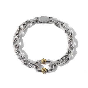 Punk style chunky chain bracelet with silver links and a gold hexagonal accent