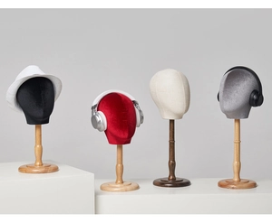 Detail of colorful velvet mannequin heads with wooden bases for hat and wig display