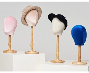 Mannequin heads for hats in pink, beige, blue and skin tones with wooden stands