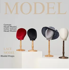 Linen and velvet hat display mannequin heads on solid wood stands for accessory stores