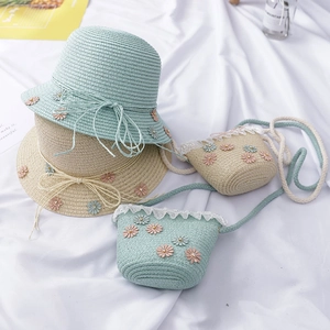 Close-up of girls straw hat and matching crossbody bag set with lace and daisy details