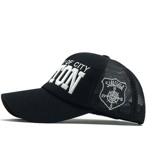 Detail of black trucker hat with white Y OF CITY 3D embroidery and breathable mesh side