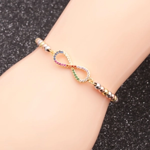 Detail of infinity symbol bracelet with multicolor crystals and mixed metal beads