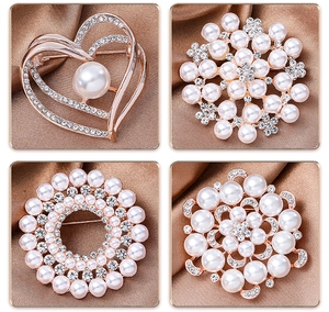 Close-up of four pearl brooch styles in rose gold finish with white rhinestones