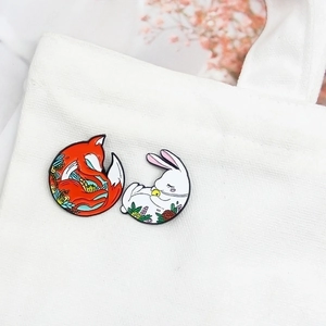 Charming enamel animal brooches with red fox and white rabbit on canvas bag