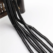 Detailed view of polished black square natural stone spacer beads for DIY jewelry making