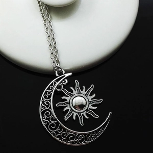 Silver alloy sun and moon pendant necklace with intricate filigree details for women