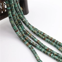 Detail of natural turquoise cylinder spacer beads with unique brown veins and blue-green hues