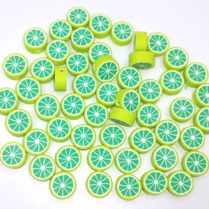 Detailed top view of green polymer clay lime fruit beads for DIY jewelry making