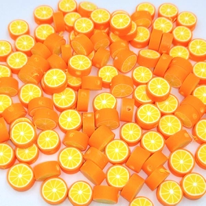 Macro shot of 10mm orange slice polymer clay beads for DIY jewelry making