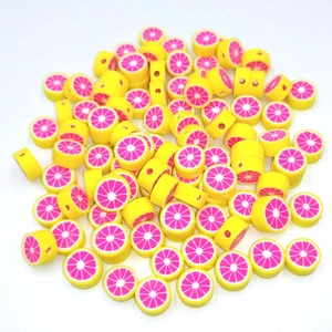 Macro detail of 10mm fruit polymer clay beads with pre-drilled holes for DIY jewelry