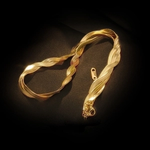 Detail of 18K gold-plated triple strand snake chain necklace with lobster clasp and extender