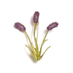 Detail of lavender brooch with purple bead cluster and green matte stems on white base