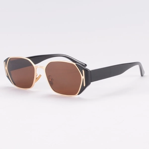 Luxury full-frame sunglasses with black acetate and gold metal details from a side angle