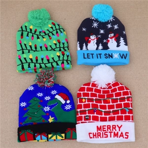 Close-up of four LED Christmas beanies featuring snowman and dinosaur knit patterns