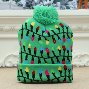 Close-up of green knitted Christmas beanie with colorful light bulb patterns and a pom-pom