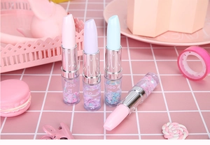 Detail view of lipstick-shaped pens with colorful liquid sand and glitter sequins