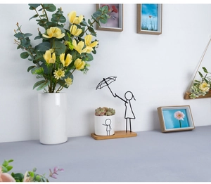Detail of creative ceramic planter with human wireframe and umbrella iron support