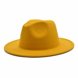 Close-up of bright yellow wool fedora hat crown featuring classic dented shape and fine stitching
