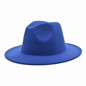 Angled view of a classic royal blue wool fedora hat with a teardrop crown and flat brim