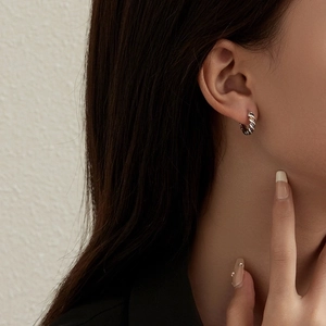 Retro twisted rope silver and black hoop earrings shown on a model for a minimalist look