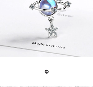 Detailed macro view of silver star and planet pendant with blue zircon stones
