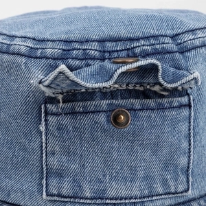 Blue washed denim bucket hat featuring a vintage side pocket and copper metal snap button