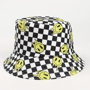 Detail of checkered bucket hat featuring a melting yellow smiley face print on canvas
