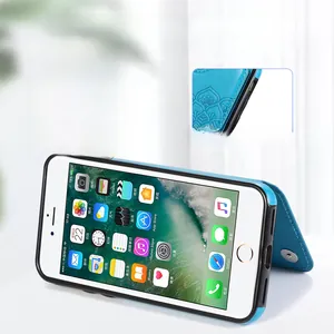 Detail of teal leather flip case for iPhone showing mandala embossing and kickstand