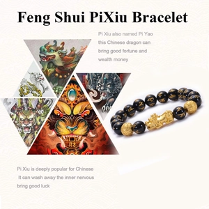 Macro detail of natural black obsidian beads and golden Pixiu charm on Feng Shui bracelet