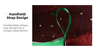 Close-up of green Christmas gift box featuring silk ribbon handle and snowflake patterns