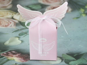 Detailed view of pink angel wing candy box with white ribbon and THANK YOU text