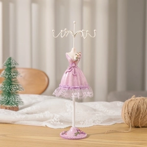 Detail of pink lace mannequin jewelry stand with floral base and multi-hook hanger