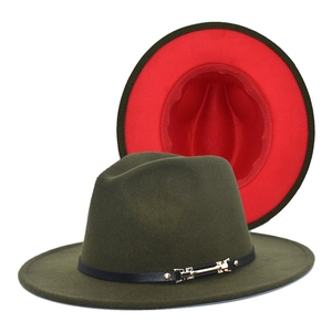 Detail of green wool fedora hat with red brim lining and black leather band with gold buckle