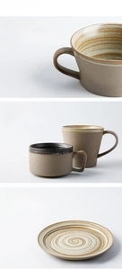 Detail of handmade stoneware coffee cup with ergonomic handle and vintage texture