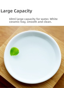 Detailed top view of a 60ml white ceramic oil burner tray on a bamboo stand