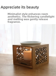 Detail of minimalist bamboo essential oil burner with white ceramic tray and lit candle