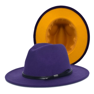 Detail of wool fedora hat with purple exterior, yellow brim interior, and leather belt