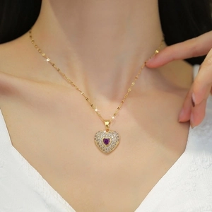 Luxurious gold heart necklace with purple gemstone and crystals for evening party