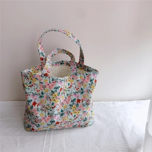 Detailed macro view of floral cotton tote bag texture with pink and yellow flower patterns