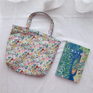 Close-up of small floral cotton tote bag with vintage flower print and double handles