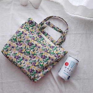 Detail shot of floral cotton tote bag showing fabric texture and vibrant pattern
