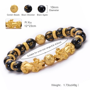 Golden PiXiu bracelet with black obsidian beads and mantra details on a white background