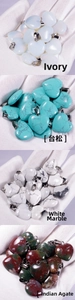 Macro shot of heart-shaped opal, turquoise and agate stone pendants with metal clips