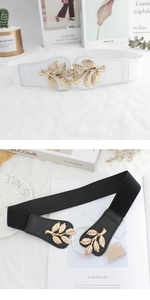 Detail of elegant gold leaf buckle and high-elastic woven texture on slim waist belts