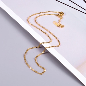 Detailed macro view of 18K gold plated necklace clasp with authentic K18 hallmark engraving