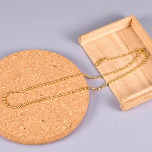 Detail of 18K gold stainless steel bead necklace with K18 engraved tag and lobster clasp
