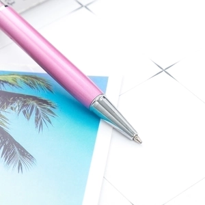 Sleek pink metal ballpoint pen with silver tip, smooth writing twist pen for office gift.