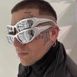 Close-up of futuristic silver Y2K sunglasses on a model with unique metallic frame details